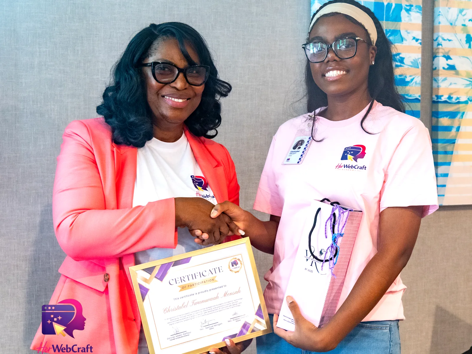 Afua Afra Yeboah presenting a Cohort 1 graduate with her certificate of participation