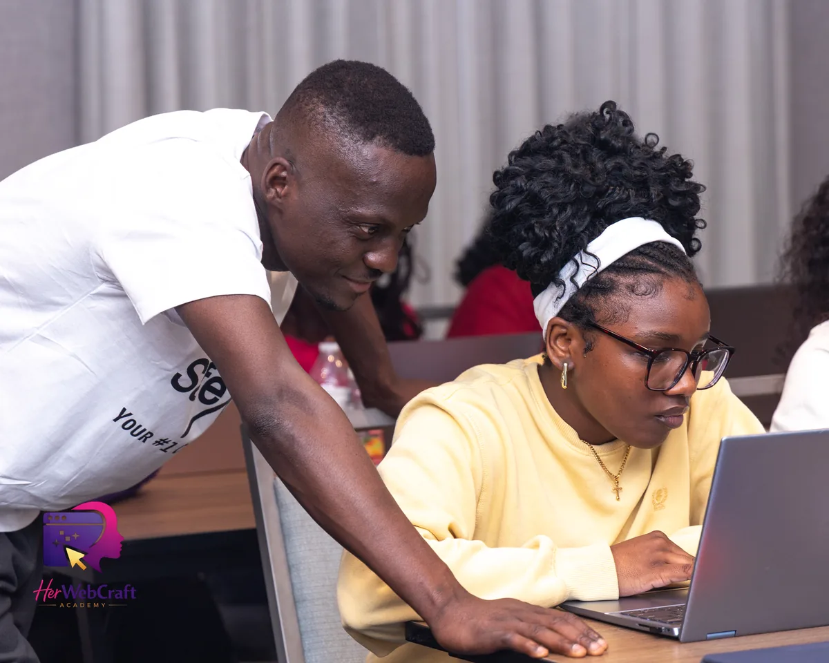 A mentor guiding a Cohort 1 student through her website build