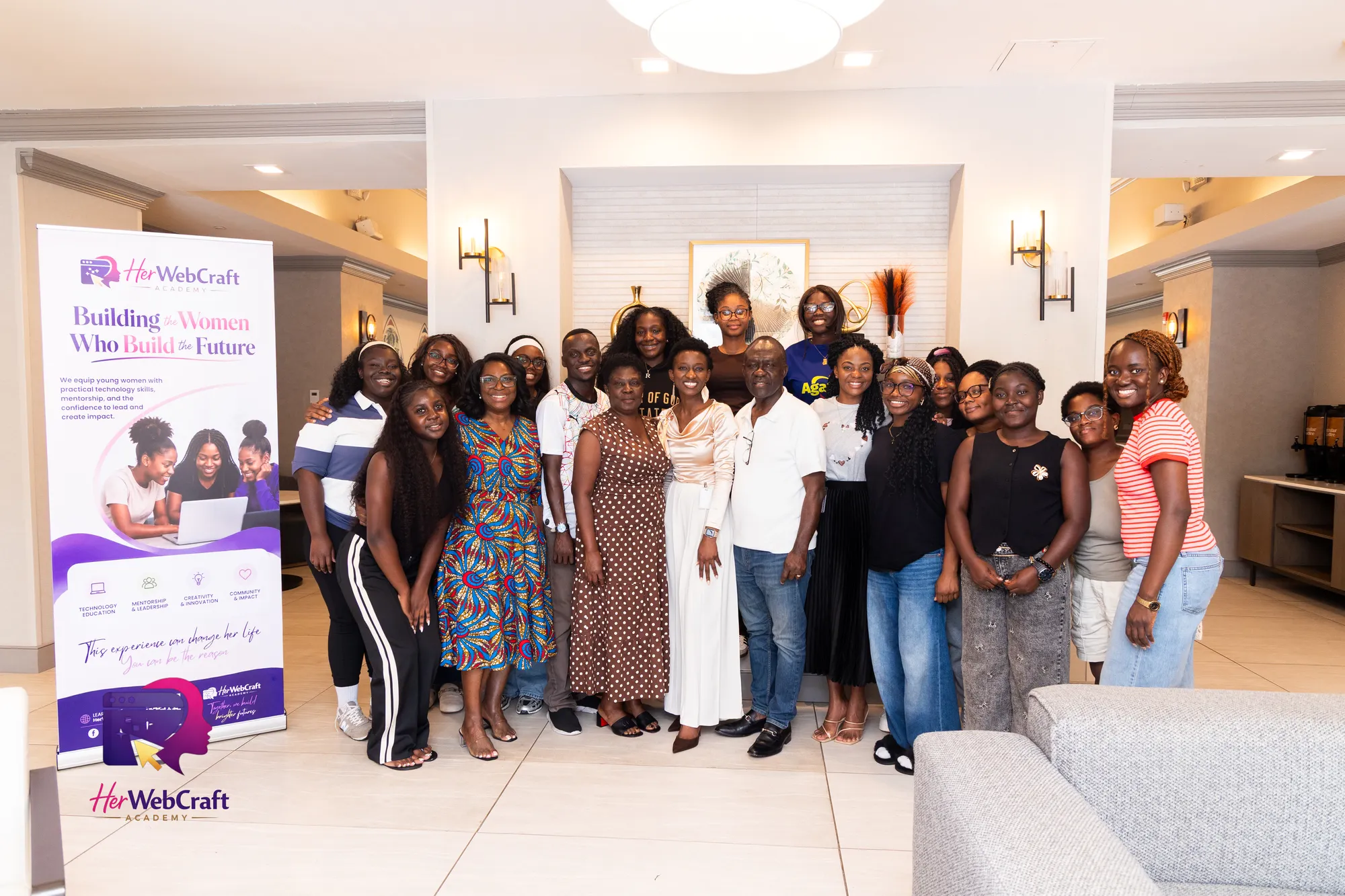 HerWebCraft Academy Cohort 1 students, mentors and supporters together beside the academy banner
