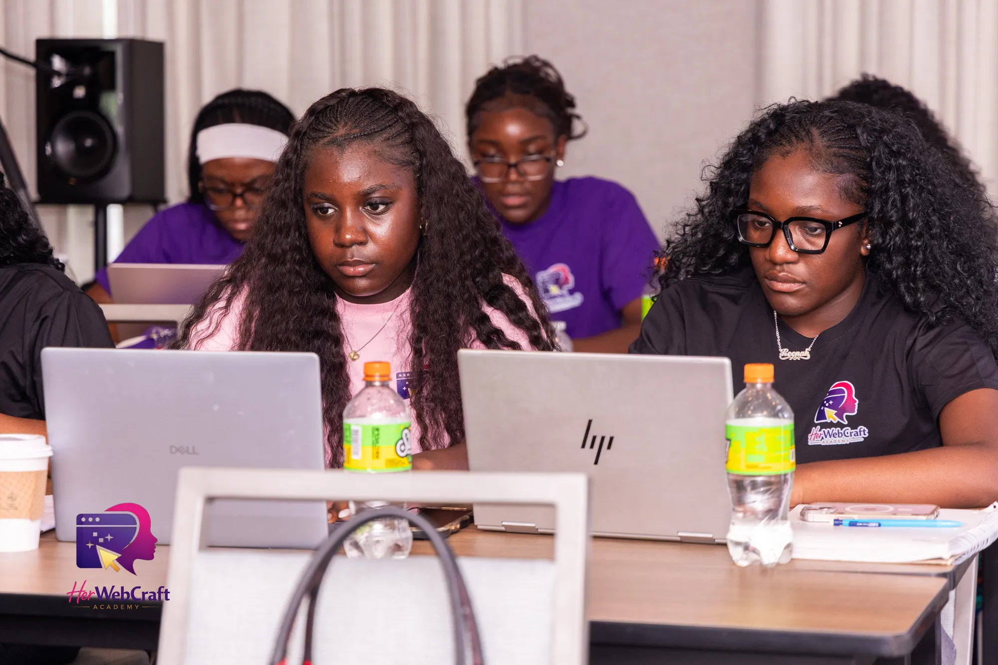 Cohort 1 students concentrating as they build their websites on laptops